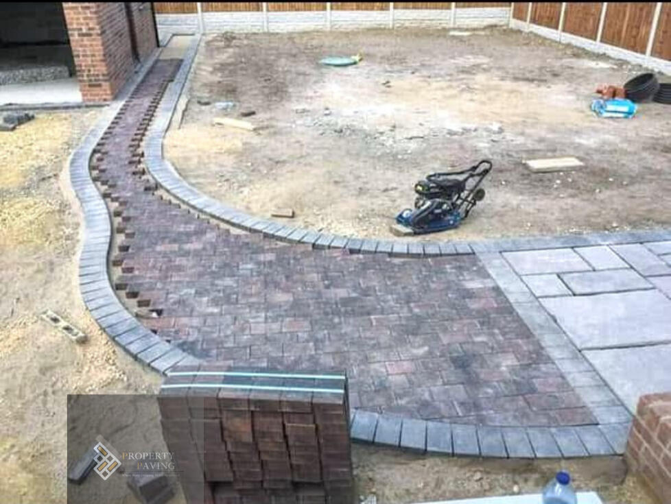 Block paving installation with drainage and edge detailing Block paving installation with levels set before surface completion