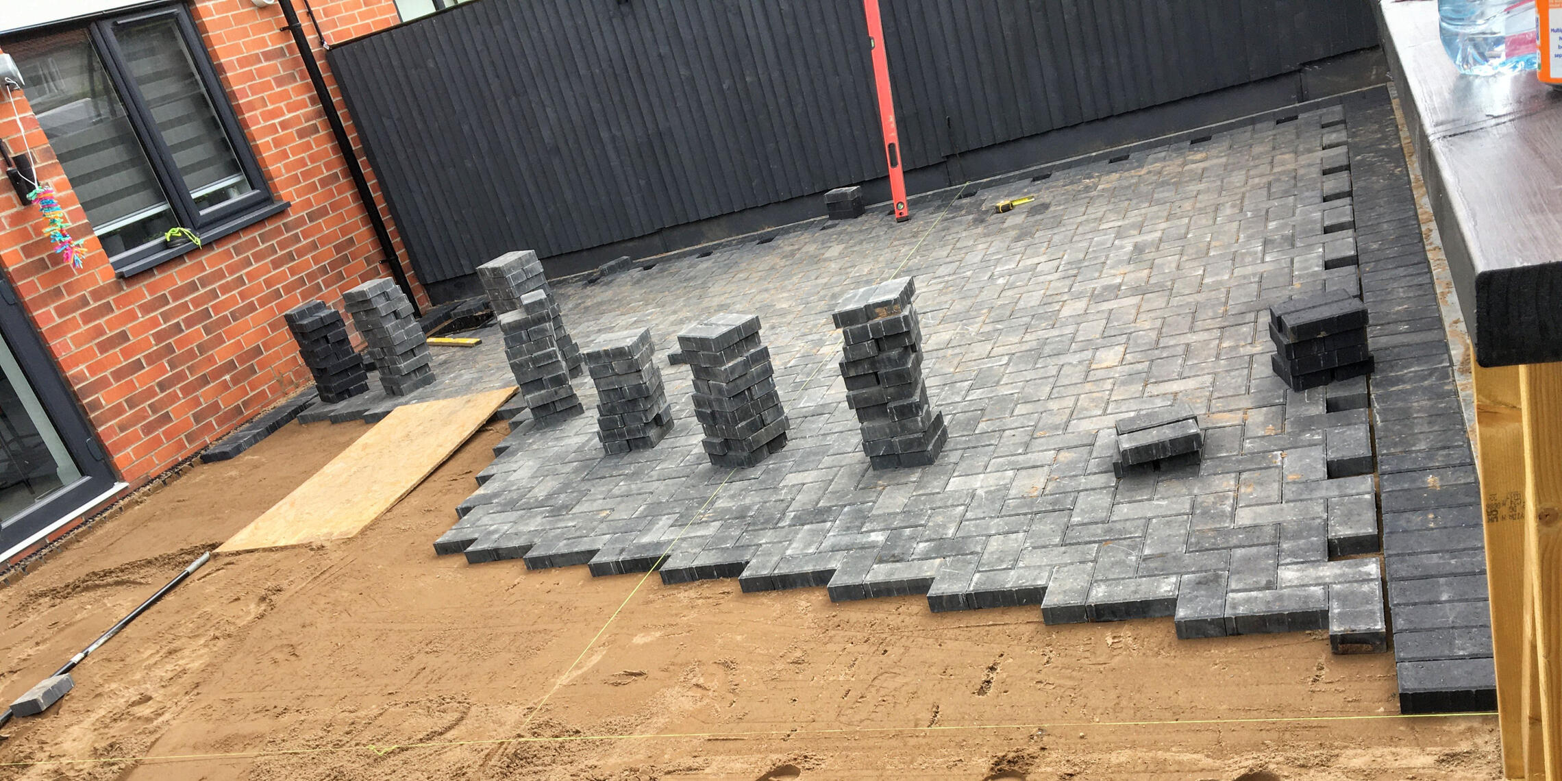 Block paving installation – preparation and setting out Block paving installation showing levels, setting out, and preparation before final surfacing